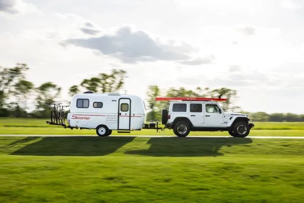 A Scamp 16ft Trailer, pulled by a Jeep